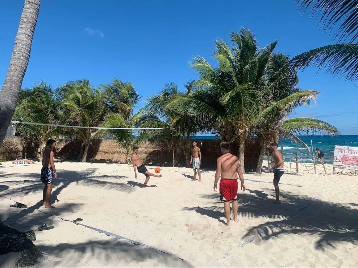 People playing football on the sand