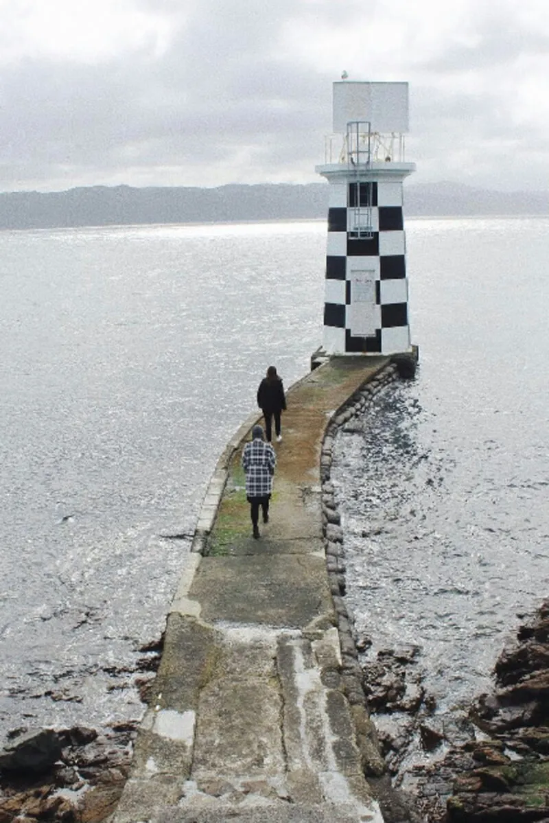 Two girls walking towards Point Halswell Lighthouse