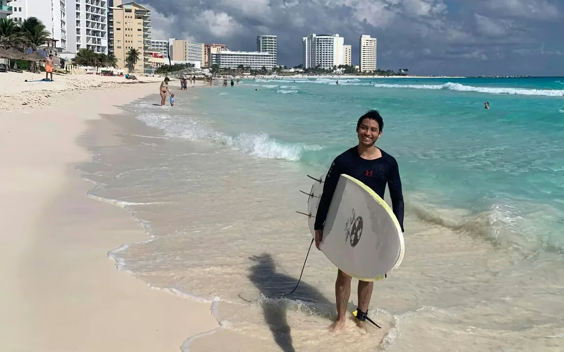 Friendly surfer local on cancun beach in Cancun mexico.