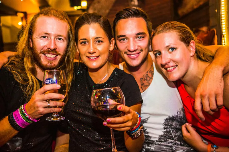 friends with drinks smiling for the camera Sultan Hostel best hostels in Istanbul