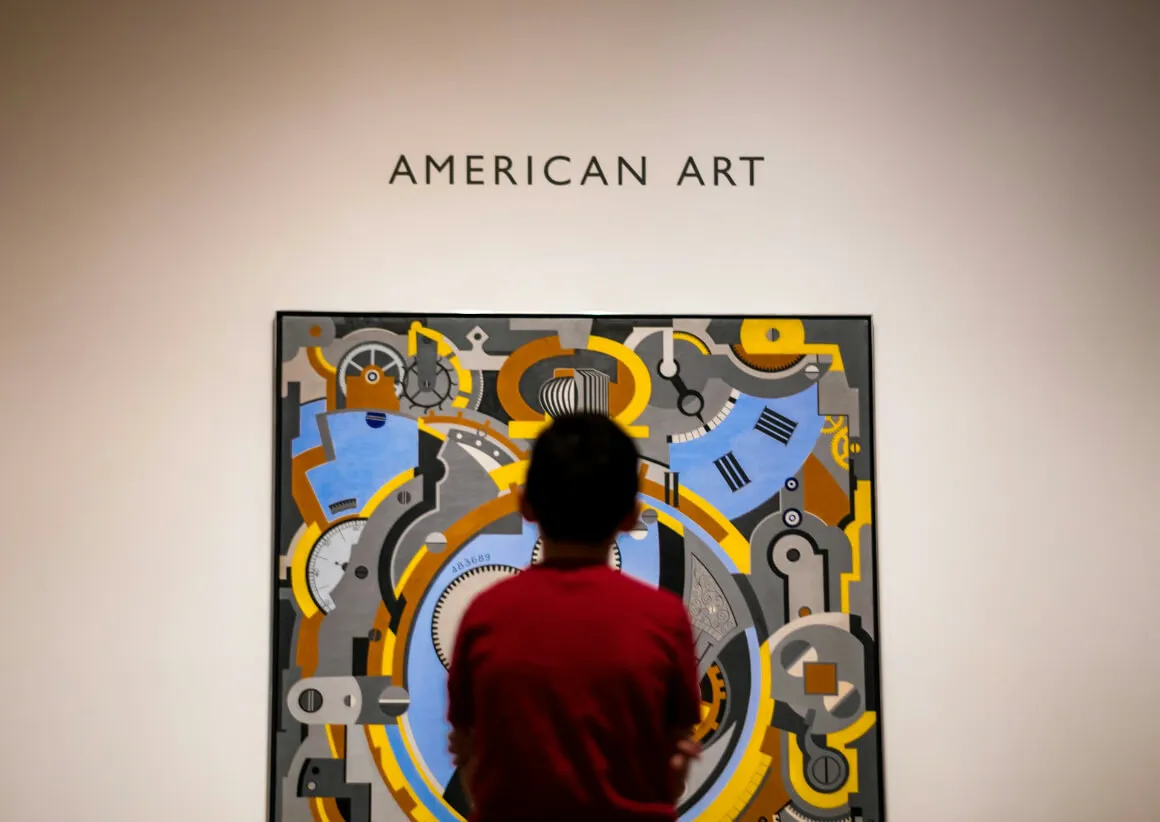 a boy looking at art in n art gallery in the arts district