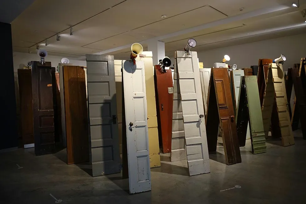 a series of cut up doors of different colours and designs in an art gallery in Sydney, Australia