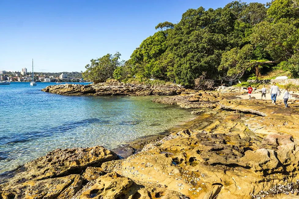 Walking along the Manley to Split coastal walk along a rocky coastline