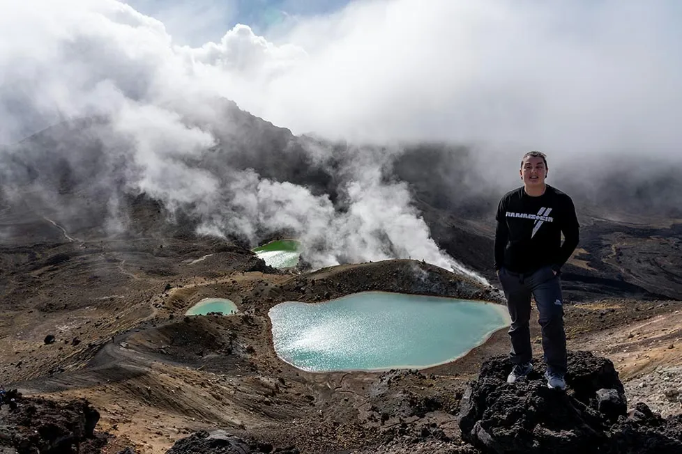 Nic standing on the red crater summit of Tongariro National Park in the north island of New Zealand