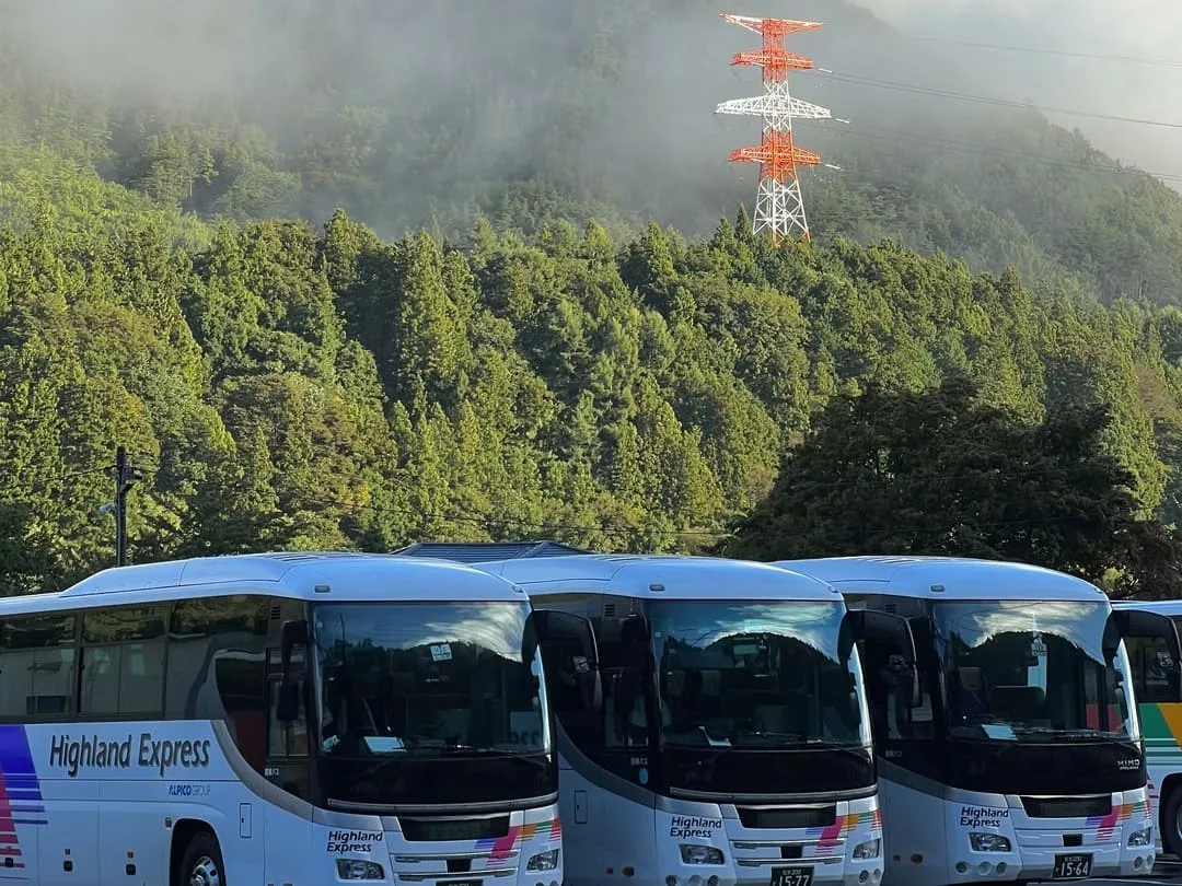 buses waiting to take people into kamikochi national park, japan