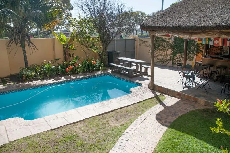 A Sunflower Stop Best Hostels in Cape Town with an outdoor swimming pool and shady area to hang out