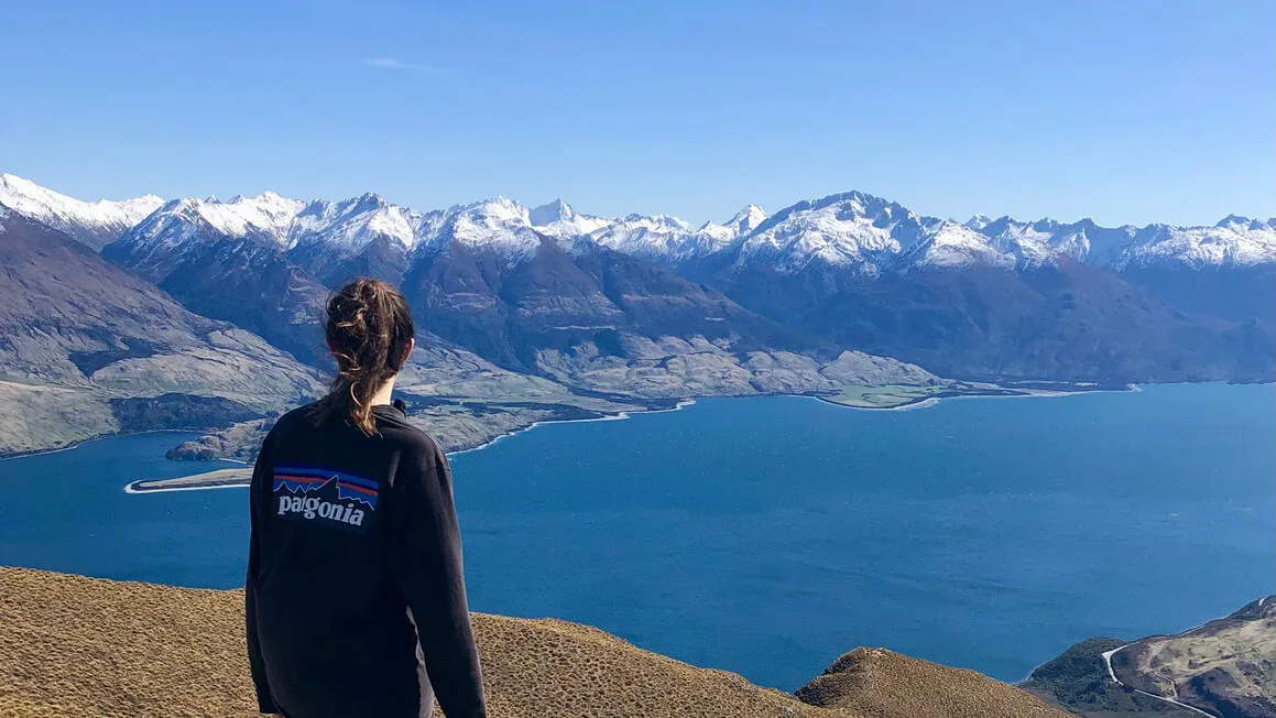 dani gazing over mountains from the summit of isthmus peak