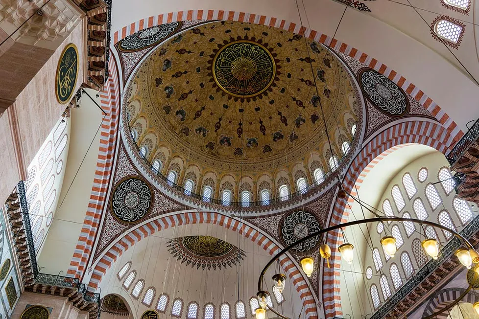 The details and ornate decoration of a dome in a mosque in Turkey