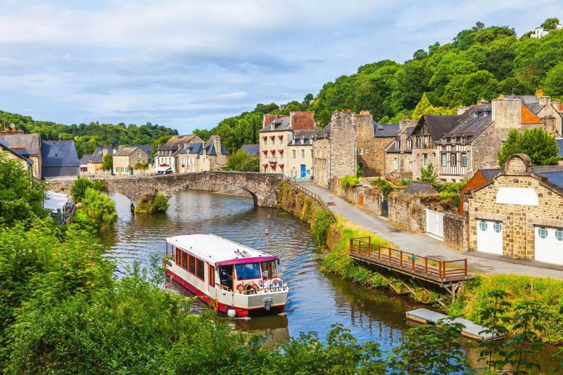 A boat crossing la Rance river in Dinan Brittany, France