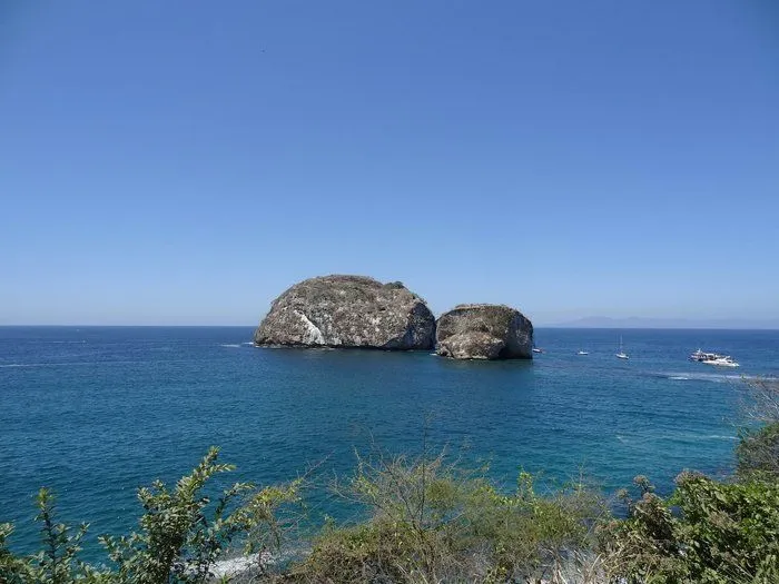 View over Los Arcos Maritime Nature Reserve. Beautiful blue water and sky with two islands seen at sea.