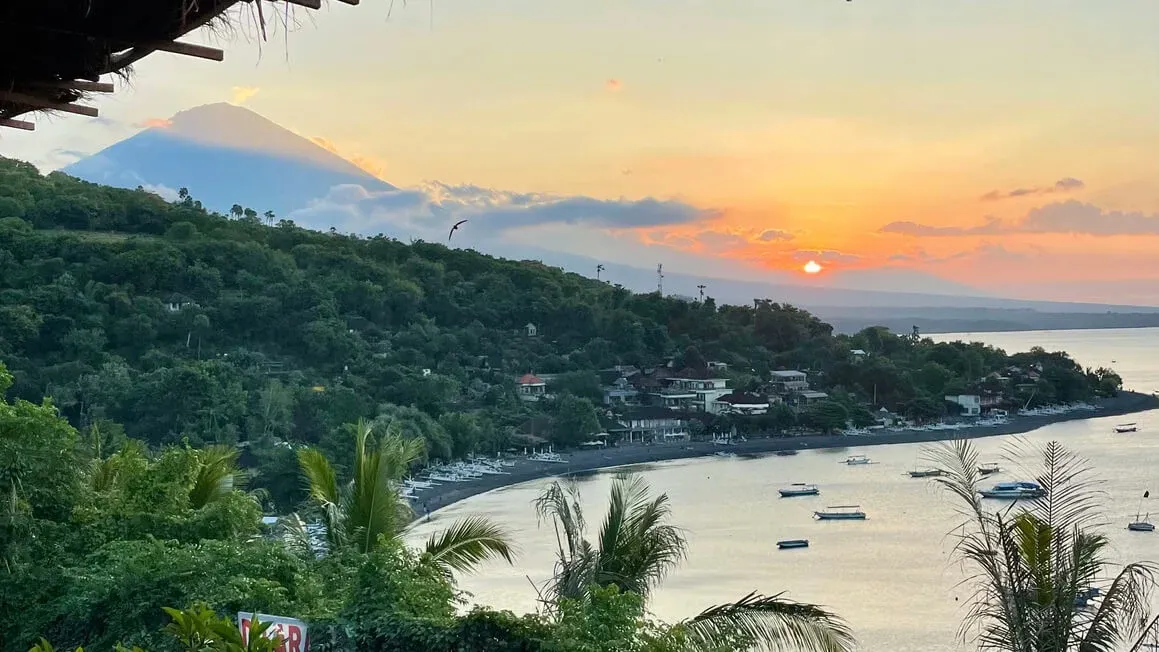 sunset view in amed across the hills, sea and mount agung, bali, indonesia