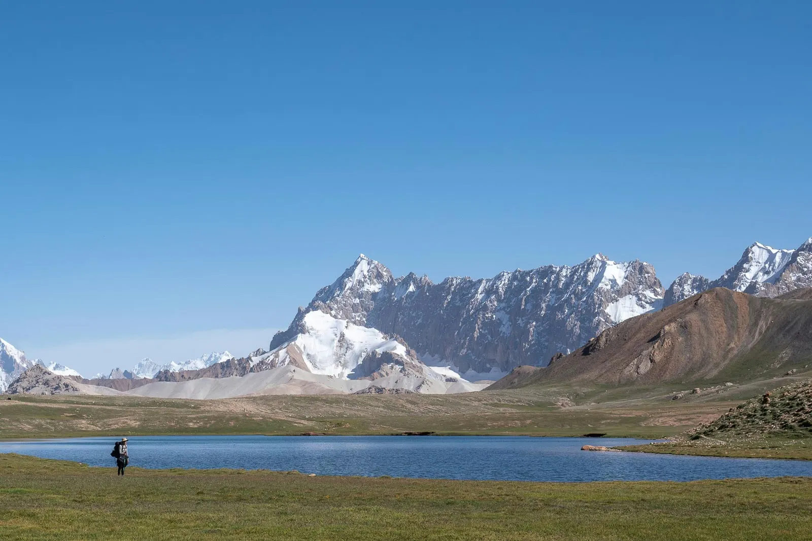 girl standing near an alpine lake in pakistan