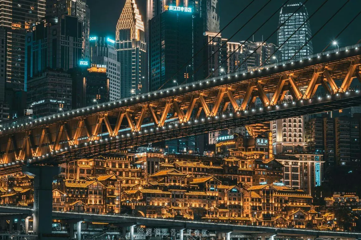 big buildings and bridge in bright city night light