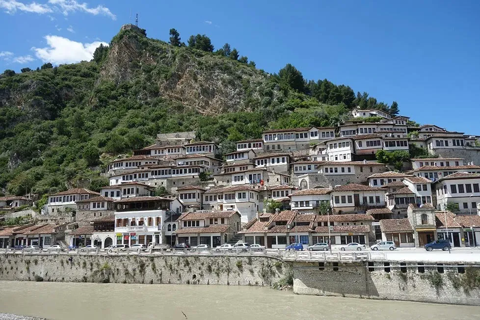 Looking across the river to the houses of Berat, Albania which are white with rediish tan roofs and plenty of windows